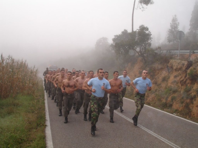 a platoon running in formation in the street